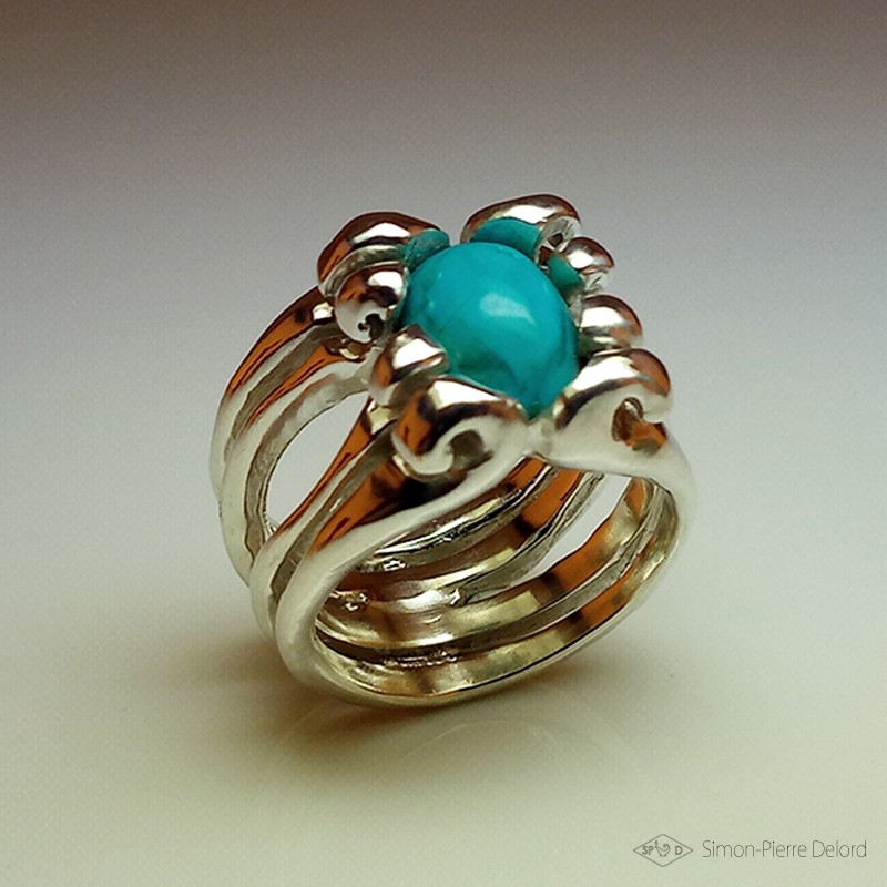 Ring in Argentium and turquoise. Title: "Treasure of the Seas", Arts and Crafts Jeweler. Lost wax in direct carving